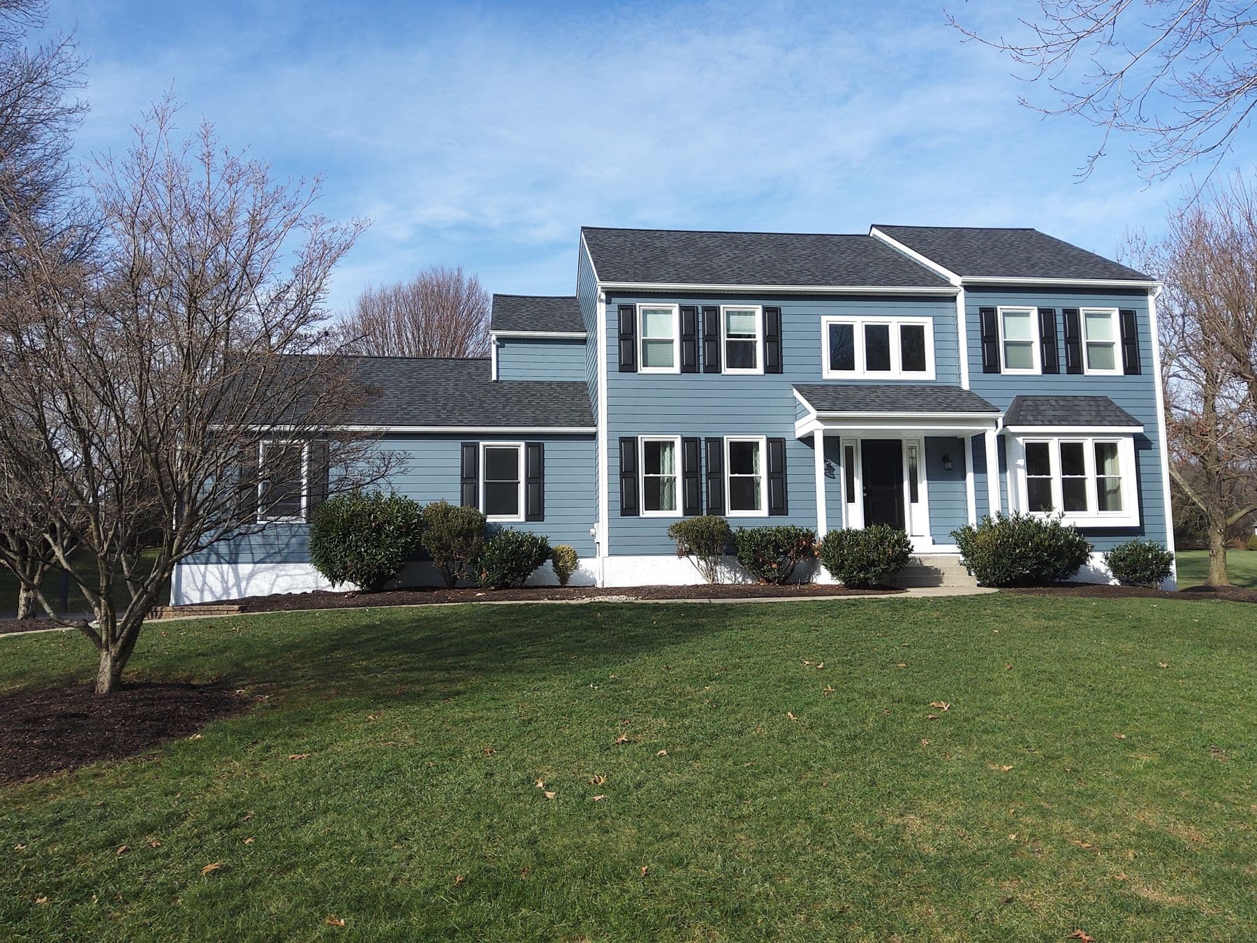 Blue Alside Ascend composite siding on a two-story colonial home